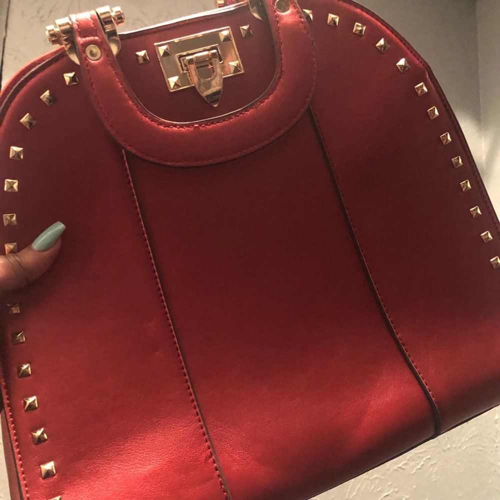Large red and gold studded purse